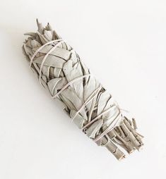 a bundle of dried white sage on a white background