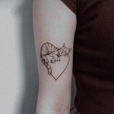 a woman with a cat tattoo on her arm