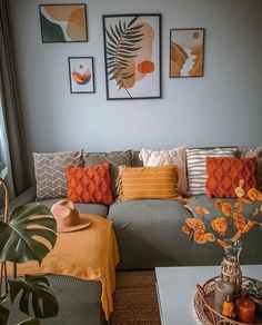 a living room filled with lots of furniture and pictures on the wall above it's couch