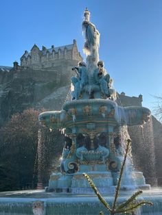 a large fountain in front of a castle