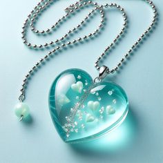 a heart shaped glass necklace with white pearls