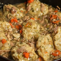 meatballs and carrots are being cooked in a skillet