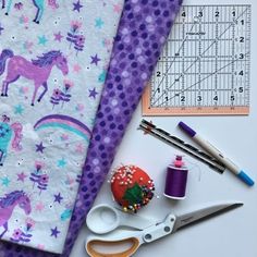 sewing supplies laid out on a table with ruler, scissors and other crafting supplies