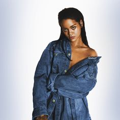 a woman in a denim jacket posing for the camera