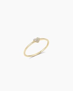 a yellow gold ring with two small diamonds on the top and bottom, set against a white background