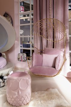 a pink chair and ottoman in a room