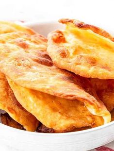 some fried food in a white bowl on a table