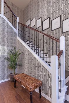 the stairs in this house are decorated with art deco wallpaper and wood flooring