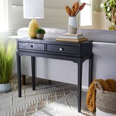 a living room with a couch, table and potted plants on the coffee table