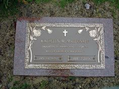 a grave with a cross on it in the grass