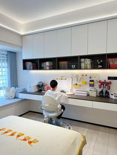 a person sitting at a desk in front of a window