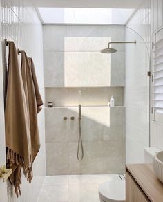 a bathroom with a shower, toilet and sink