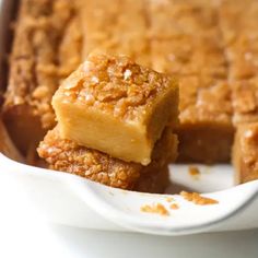 two pieces of cake sitting in a white dish