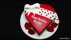 a heart shaped birthday cake with roses on it