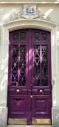 a purple door with two glass panes on it