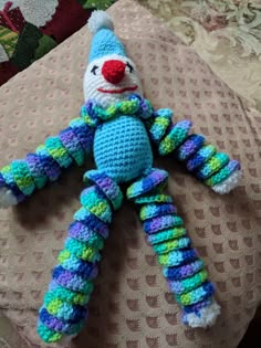 a crocheted stuffed animal sitting on top of a bed