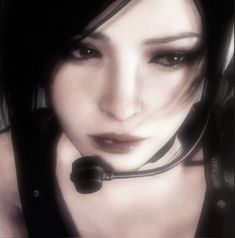 a woman with black hair wearing a headset