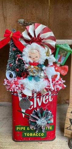 an old fashioned tin can filled with christmas decorations