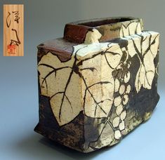 an artistically designed box with leaves and flowers on it