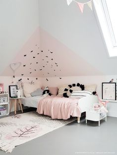 a bedroom with pink and white decor in the corner is decorated with black and white accessories