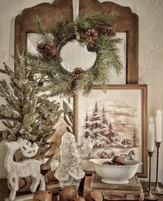 a table topped with christmas decorations and candles