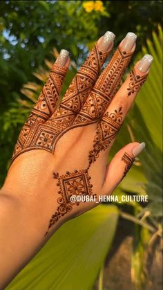 the hand is decorated with henna designs