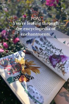 an open book with flowers in the background and text overlay that reads pov you're leaving through the encycloped ages of enchantments