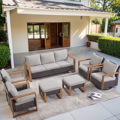 an outdoor living room with furniture on the patio