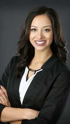 a smiling woman with her arms crossed