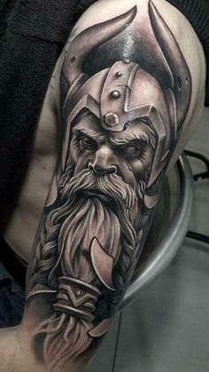 a man's half sleeve with an old viking tattoo on his arm and shoulder