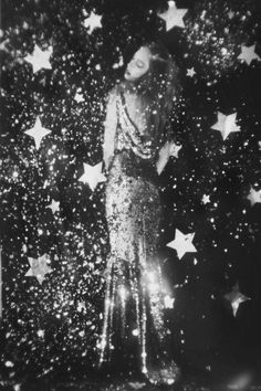 a black and white photo of a mannequin surrounded by stars