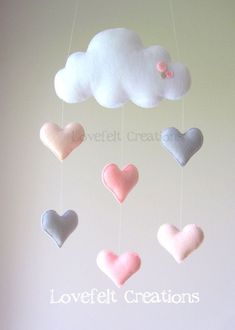 a mobile with hearts and clouds hanging from it