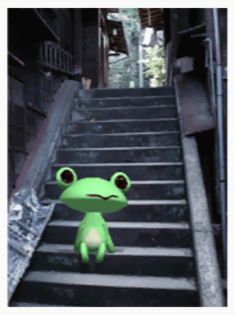 a green frog sitting on top of some stairs