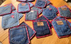 several pairs of jeans are sitting on a table with tags attached to the back of them