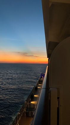 the deck of a cruise ship at sunset looking out over the ocean and into the distance