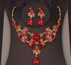 a necklace and earring set with red stones