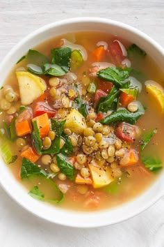 a white bowl filled with soup and vegetables