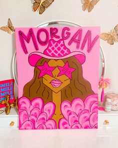 there is a pink sign that says morgan on the front and back of it, with butterflies in the background