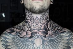 a man with tattoos on his chest and neck