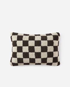 a black and white checkered pillow sitting on top of a table