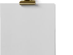 a clipboard with a white sheet of paper attached to it and a gold handle