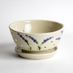 a white bowl with blue flowers painted on it