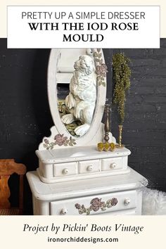 a white dresser sitting next to a mirror on top of a wooden table in front of a black wall