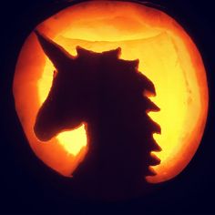 a close up of a carved pumpkin with a horse's head in the center