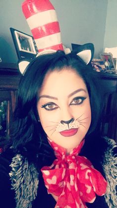 a woman wearing a cat mask with a red scarf around her neck and black hair