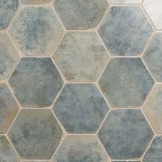 a tile floor with blue and gray hexagonal tiles on it's sides