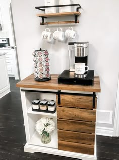 a coffee maker on top of a wooden cabinet