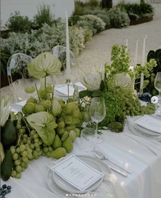 the table is set with white plates and silverware