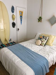 a bedroom with two surfboards on the wall and a bed in front of it