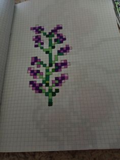 a piece of paper that has been made into a cross stitch pattern with flowers on it